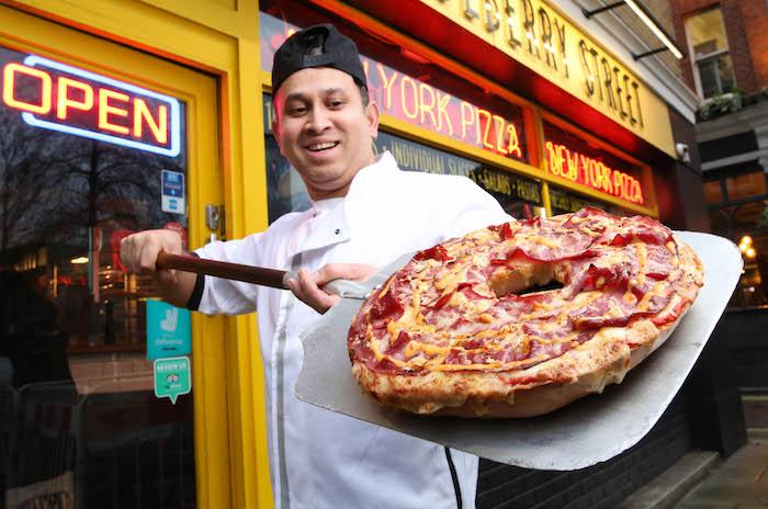 EMBARGOED TO 0001 THURSDAY FEBRUARY 7 EDITORIAL USE ONLY Chef, Nashir Uddin prepares the UK’s first 12-inch ‘Bagelizza’, a cross between a bagel and pizza, which has been created by the New York Bakery Co. to celebrate both National Bagel Day and National Pizza Day this Saturday 9th February, and will be given away for free from midday at Mulberry Street Pizza in London, through Deliveroo and in-store. PRESS ASSOCIATION Photo. Issue date: Thursday February 7, 2019. Boiled and baked the New York way, each of the bakes is made by hand and weighs 1.5kg. The deep dish ‘Bagelizza’ features the classic New York deli flavours of the ‘Reuben’, with 21-day-aged grass-fed brisket, cured pastrami, sauerkraut, shavings of Swiss cheese and a drizzle of Russian dressing, and can serve up to eight people. Photo credit should read: Matt Alexander/PA Wire
